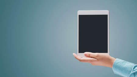 Woman holding a digital tablet and blank copy space, technology and communication conceptの写真素材