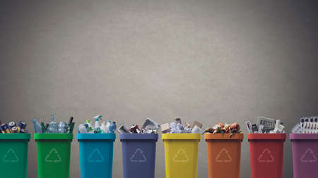 Collection of waste bins full of different types of garbage, recycling and separate waste collection conceptの写真素材
