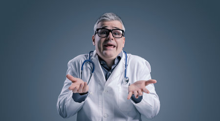 Funny doctor with lab coat, he is looking at camera and shruggingの写真素材