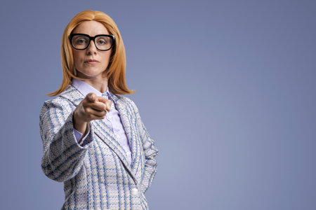 Aggressive confident woman pointing at camera and giving orders, blank copy spaceの写真素材