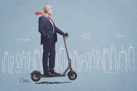 Corporate businessman riding an eco-friendly electric scooter and sketched city in the background, smart mobility conceptの写真素材