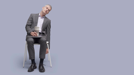 Lazy tired businessman sitting on a chair and falling asleep