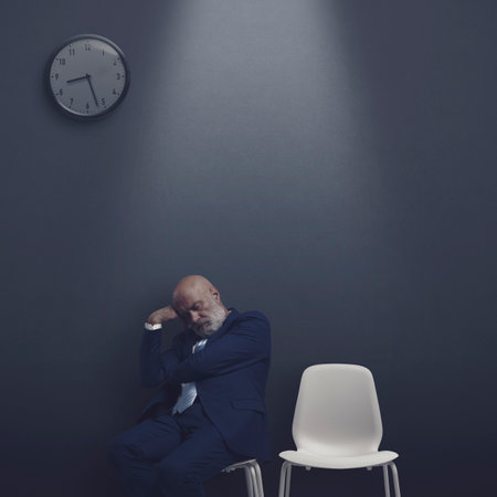 Businessman sleeping in the waiting room at night, he has been waiting all day long for the interviewの写真素材