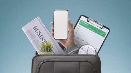 Businessman holding a smartphone and office equipment in a briefcase: business, expertise and...