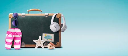 Vintage suitcase and colorful beach accessories, summer vacations concept, copy spaceの写真素材