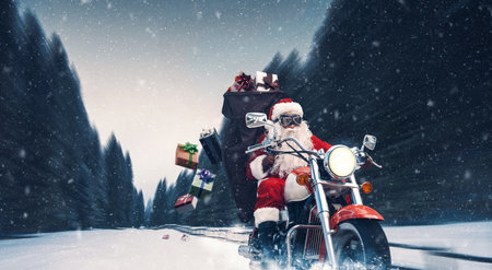 Unconventional biker Santa Claus riding a fast motorbike and delivering Christmas giftsの写真素材