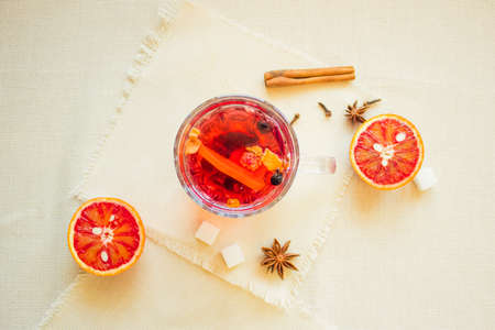 Tea made from dried fruit, seasoned with cinnamon cloves and anise seeds. There is an orange nearbyの写真素材