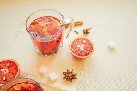 Tea made from dried fruit, seasoned with cinnamon cloves and anise seeds. There is an orange nearbyの写真素材