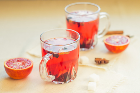 Tea made from dried fruit, seasoned with cinnamon cloves and anise seeds. There is an orange nearbyの写真素材