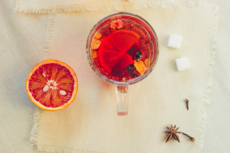 Tea made from dried fruit, seasoned with cinnamon cloves and anise seeds. There is an orange nearbyの写真素材