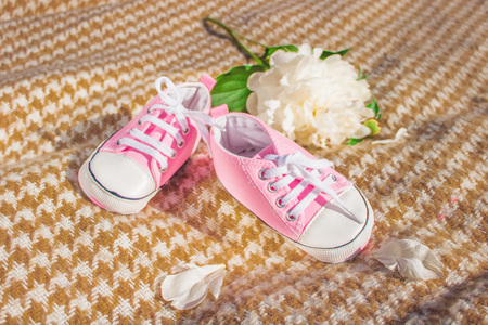 Babys booteeson a beige plaid. Childrens shoesの写真素材