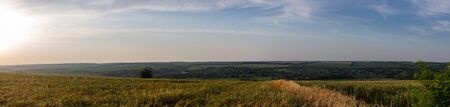 Sunset over the field. In the distance you can see the village.の写真素材