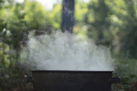 Cooking at the stake. Boiling water in a pan.の写真素材