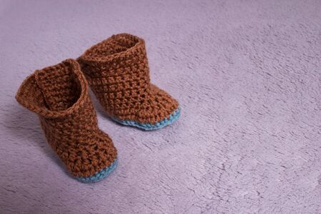 Knitted boots. Knitted shoes. Booties for babies. Made by hands.の写真素材