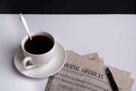 Espresso in coffee shops and reading the news in the newspaper