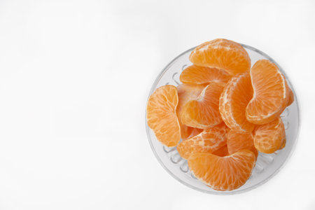Tangerines in a vase, plate close-up. Space for text, empty spaceの写真素材