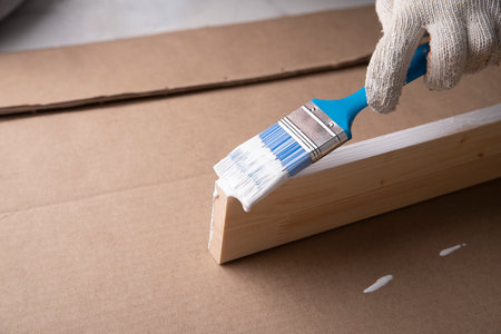 Painting with a brush of natural boards, furniture. Home renovation.の写真素材