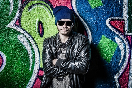 a young guy posing on bright wallの写真素材