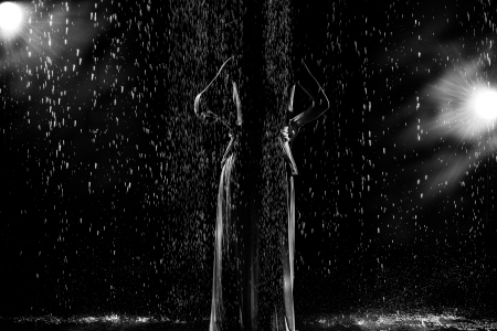 Black and white abstract fashion portrait of young woman in the rainの写真素材