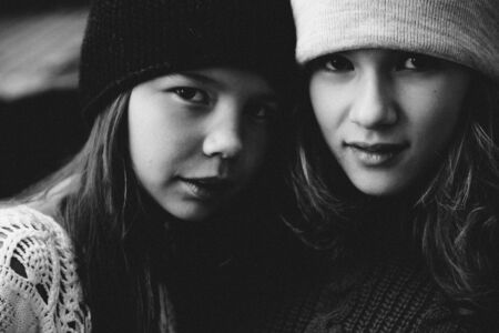 Two girls playing in the sun street togetherの写真素材