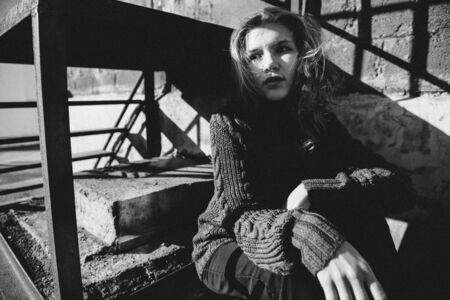 Young girl playing with light in the sunny streetの写真素材