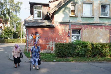 Two elderly women walking down the streetの写真素材