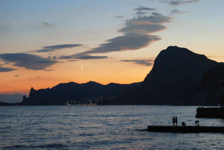 Crimean seascape at sunset. The silhouettes of the mountain and the sea.の写真素材