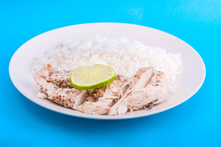Chicken, rice, lemon, slice, white, plate, blue backgroundの写真素材