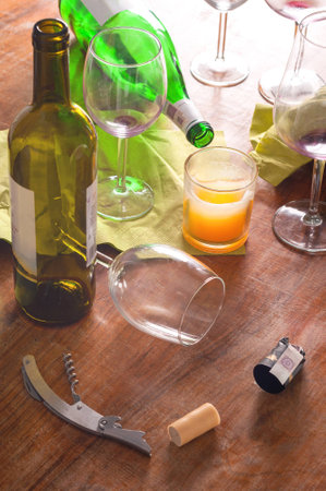 Mess after party with wine drinking  Few glasses, bottles and everything not clean の写真素材