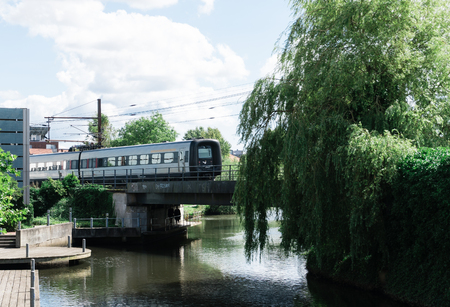 local train crosses a canal on a bridge in Aarhus.