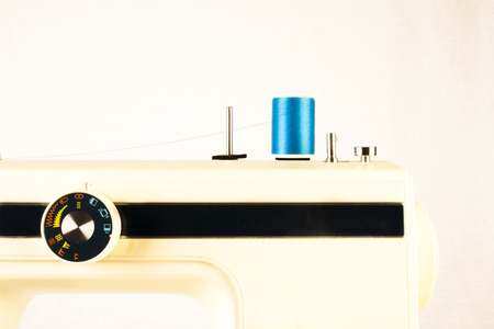 Closeup of a vintage sewing machine with blue thread. Retro styleの写真素材