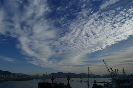 cloudy sky in a port with cranesのeditorial素材