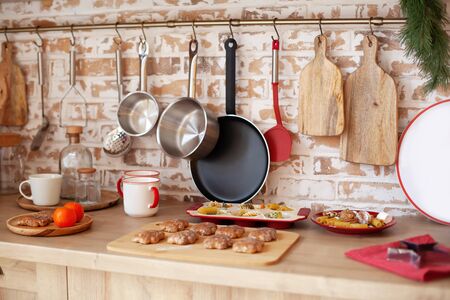 Bright kitchen interior with red decor and christmas decorations. Cooking a festive dinner at home...