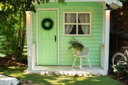 Exterior Wooden porch home with garden furniture. Interior Cozy veranda house with chair and basket...