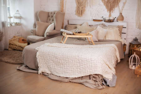 interior of the bedroom with a bed and a lamp in the style of bohoの写真素材