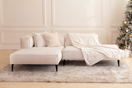 Elegant modern interior living room with large light corner sofa. Comfortable couch with three...