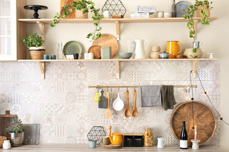 Stylish scandi cuisine interior decor. Plates, utensils and cozy decor on wooden shelves. Kitchen...