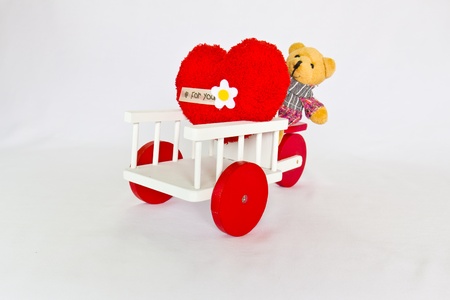 Red heart and bear on a tricycle.の写真素材
