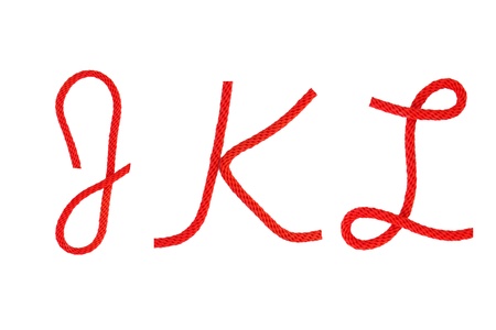 Red fiber rope bent in the form of letter J,K,Lの写真素材