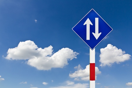 Curved Road Traffic Sign over blue skyの写真素材