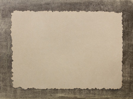 Vintage grunge burnt paper on brown backgroundの写真素材
