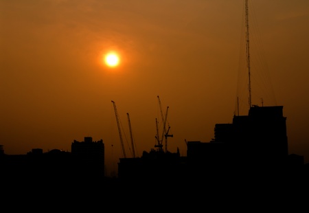 City under construction at sunrise silhouetteの写真素材