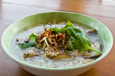 Asian style rice soup with herbs in a bowlの写真素材