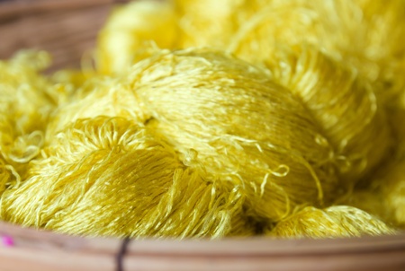 Sewing threads silk golden color  in basketの写真素材