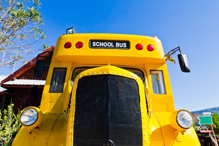 Yellow school bus against blue skyの写真素材