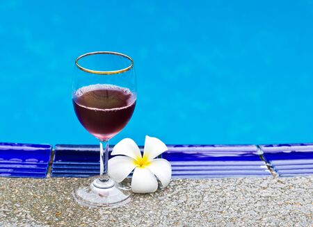 Red wine glasses and flower at the pool  Relaxing sceneの写真素材