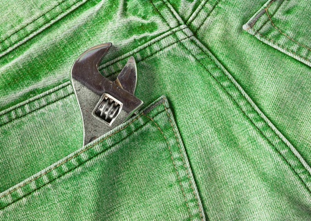Green jeans pocket with old toolの写真素材