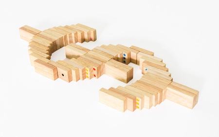 Symbol of dollar from wooden domino on white background
