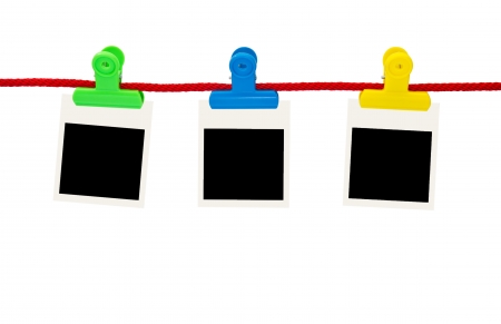 Blank photo frames Hanging by plastic peg on white backgroundの写真素材