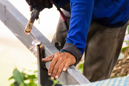 Welder welding  elements at the  construction site